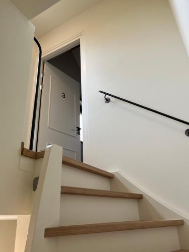 a stairway with a door and a mirror at De Hoogstam in Vijlen
