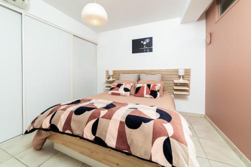 a bedroom with a large bed in a white room at plage st jean RESIDENCE LE GOLFE D AZUR in La Ciotat