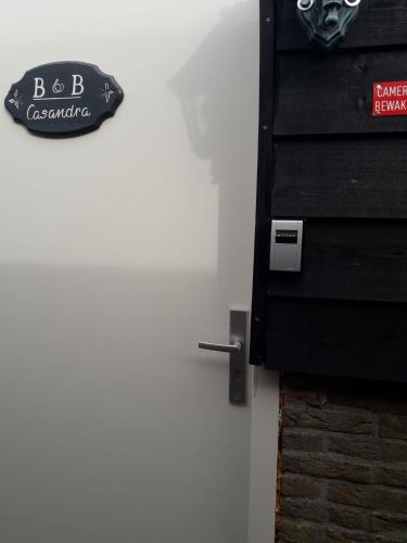 a door with a skull sign on the wall at B&B CaSandra in Volendam