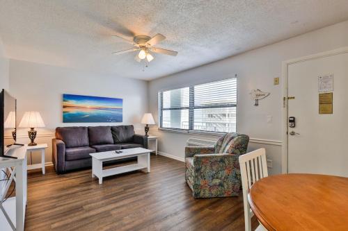 a living room with a couch and a table at Coastal Waters in New Smyrna Beach