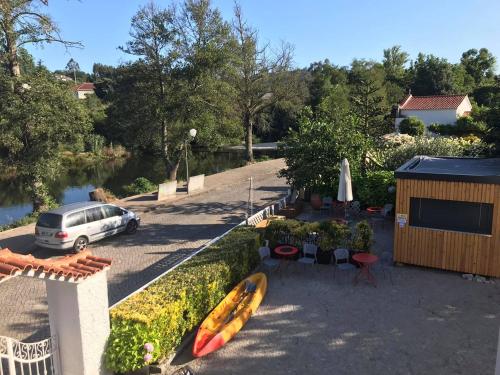 a car parked in a parking lot next to a river at Casa da Avó Olinda in Góis