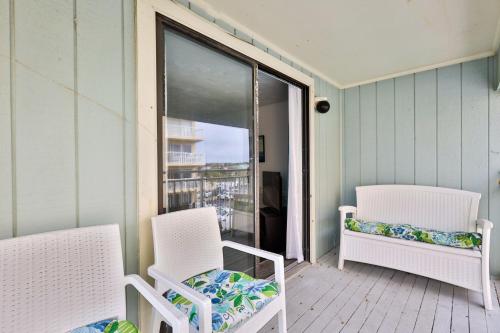 two chairs and a bench on a porch at Coastal Waters in New Smyrna Beach
