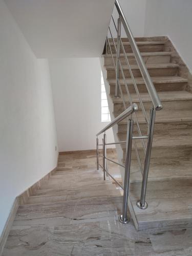 a staircase with a metal railing and wooden floors at Apartmani Josipa in Baška Voda