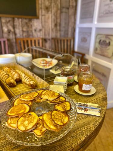 a table topped with a plate of bread and honey at Villa St. Tropez in Prague
