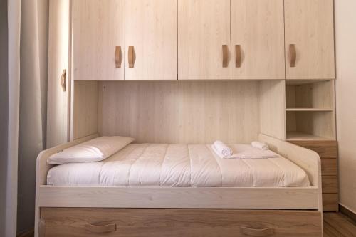 a bed in a room with wooden cabinets at Casa Riccio in Cala Gonone