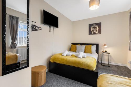 a bedroom with a bed and a mirror at Clase Accommodation - TV in Every Bedroom! in Morriston