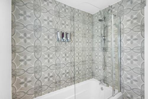 a bathroom with a shower and a tub at Byng! This one's for you - TV in Every Bedroom! in Morriston