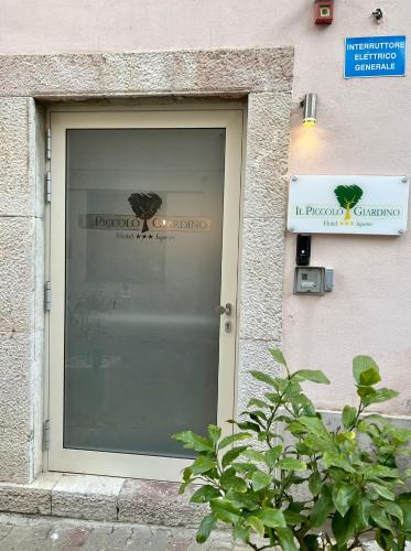 a window of a store with a sign on it at Il Piccolo Giardino GH ***Superior in Taormina