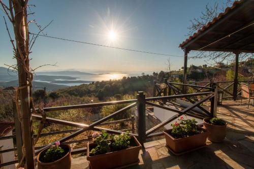 a view from the balcony of a house with potted plants at My Pelion Home in Lafkos