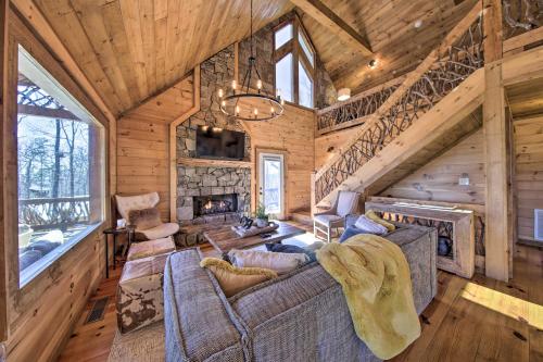a living room with a couch and a fireplace at Stunning Escape with Loft, Hot Tub and Mtn Views! in Morganton