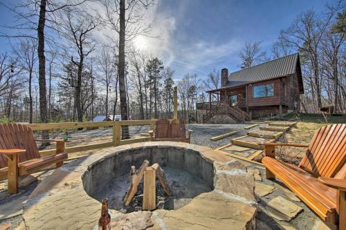a fire pit with benches and a log cabin at Stunning Escape with Loft, Hot Tub and Mtn Views! in Morganton