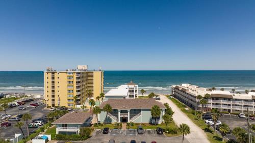 a view of the beach and buildings and the ocean at Coastal Waters in New Smyrna Beach