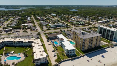 an aerial view of a resort with a pool and buildings at Coastal Waters in New Smyrna Beach