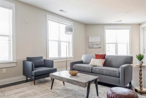 a living room with a couch and two chairs at Kasa Dilworth Charlotte in Charlotte