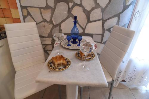 a table with wine glasses and a turkey on it at Pasas Castle - Unique Luxury Apartments in Naxos Chora