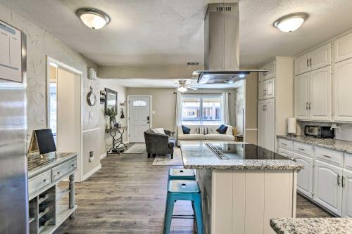 a kitchen with white cabinets and a blue stool at 1 Mi to ATandT Stadium Downtown Arlington Home in Arlington