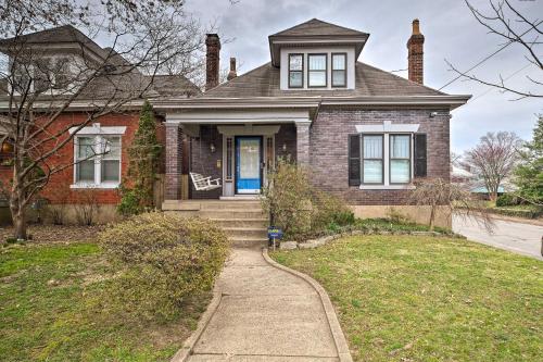 a brick house with a blue door and a sidewalk at Louisville Home with Hot Tub in The Highlands! in Louisville
