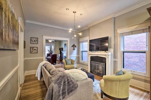 a living room with two couches and a fireplace at Louisville Home with Hot Tub in The Highlands! in Louisville