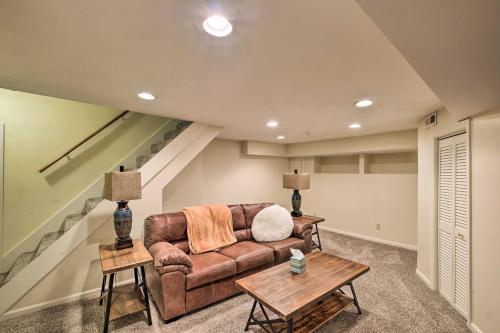 a living room with a couch and two tables at Louisville Home with Hot Tub in The Highlands! in Louisville