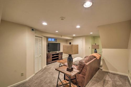 a living room with a couch and a table with a lamp at Louisville Home with Hot Tub in The Highlands! in Louisville