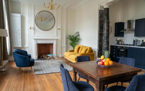 a living room with a wooden table and blue chairs at Charrington House in London