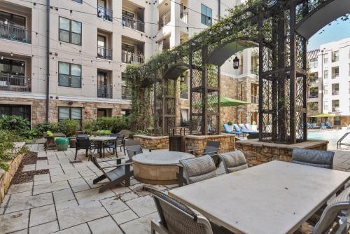 a patio with tables and chairs in a building at Kasa Dilworth Charlotte in Charlotte