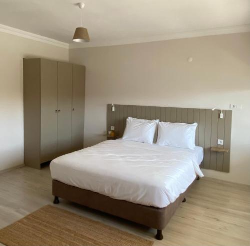 a bedroom with a large bed with white sheets and pillows at Well Hotel Edirne in Edirne