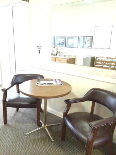 a table and two chairs and a table and chairs at Island Inn in Grand Island