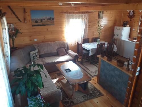 a living room with a couch and a table at Mountain house Catherine in Žabljak