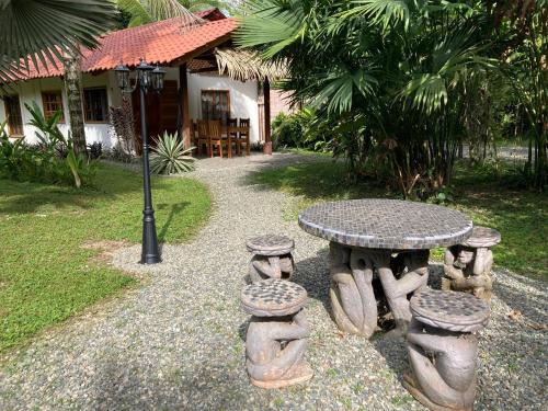 a table and stools in front of a house at Pura Vida Vegana in Cahuita