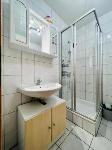 a bathroom with a sink and a shower at Haus Lechbruck in Lechbruck