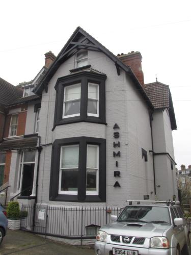 a house with a car parked in front of it at Ashmira Guest House in Weymouth