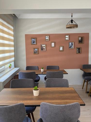 a waiting room with tables and chairs and pictures on the wall at Well Hotel Edirne in Edirne