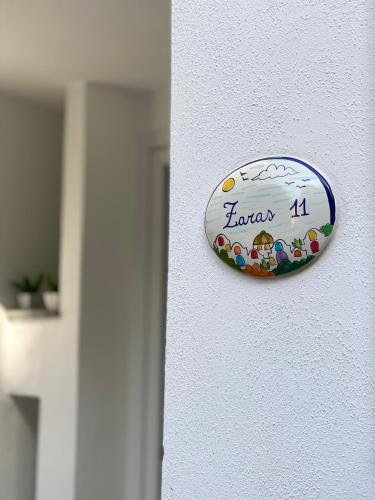 a sign on a wall that says kanza at Zaras in Lacco Ameno