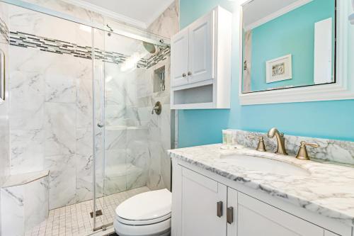 a bathroom with a shower and a toilet and a sink at Oceanside 306-B in Isle of Palms
