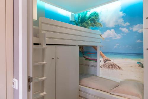 a bedroom with a mural of the beach at Appartement Volendam in Volendam