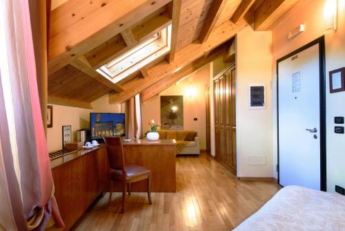 a room with a bed and a desk with a chair at Locanda San Paolo in Monza