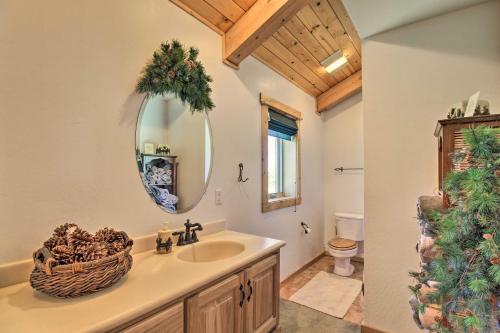 a bathroom with a sink and a mirror at Hot Tub, Game Room and Theater Luxe Show Low Home in Show Low