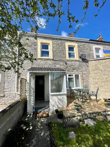 a brick house with a patio in front of it at Number 8 Clandown in Radstock