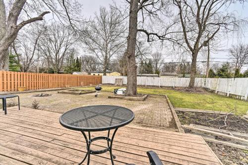 a table and chairs on a wooden deck at Bright Ann Arbor Home with Yard, 3 Mi to U of M in Ann Arbor