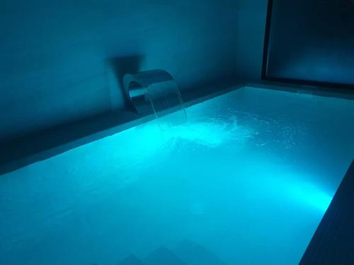 a swimming pool with blue lights in a room at Las vistas del valle in Hontoba