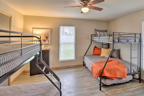 a bedroom with two bunk beds and a ceiling fan at Historic West Plains Home Walk to MSU and Dtwn in West Plains
