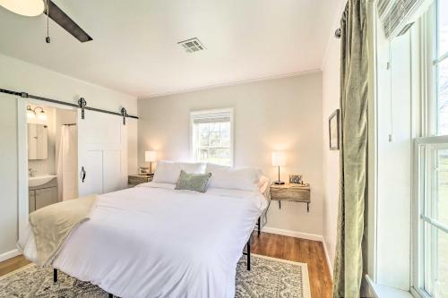 a white bed in a room with a window at Lake Eufaula Retreat with Fire Pit, Near Main St! in Eufaula