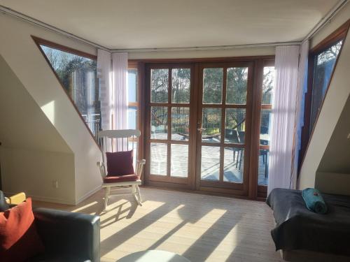 a living room with a sliding glass door at Elling Bed & Breakfast in Frederikshavn