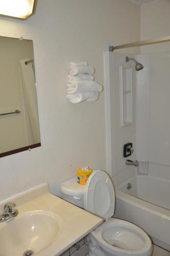 a bathroom with a sink and a toilet and a shower at Heritage Inn in Beaumont