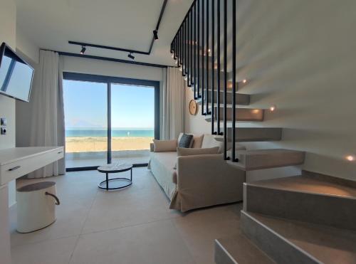 a living room with a couch and a view of the ocean at Onar in Sarti in Sarti