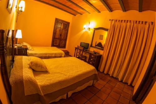 Postel nebo postele na pokoji v ubytování Hotel Bodega La Venta