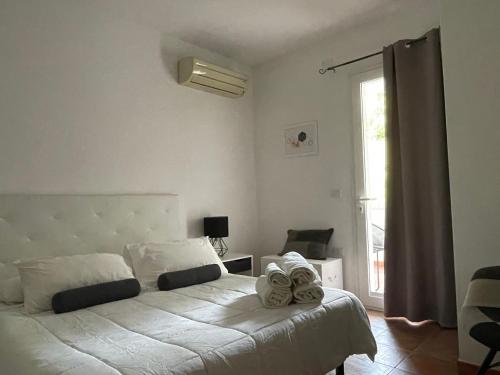 a bedroom with a bed with towels on it at Appartamenti ucuppu in Carloforte