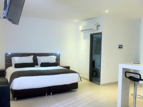 Ένα ή περισσότερα κρεβάτια σε δωμάτιο στο Hausen Hotel - Suites