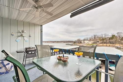 a patio with a table with wine glasses on it at Pool and Boat Slip Available Osage Beach Condo! in Osage Beach